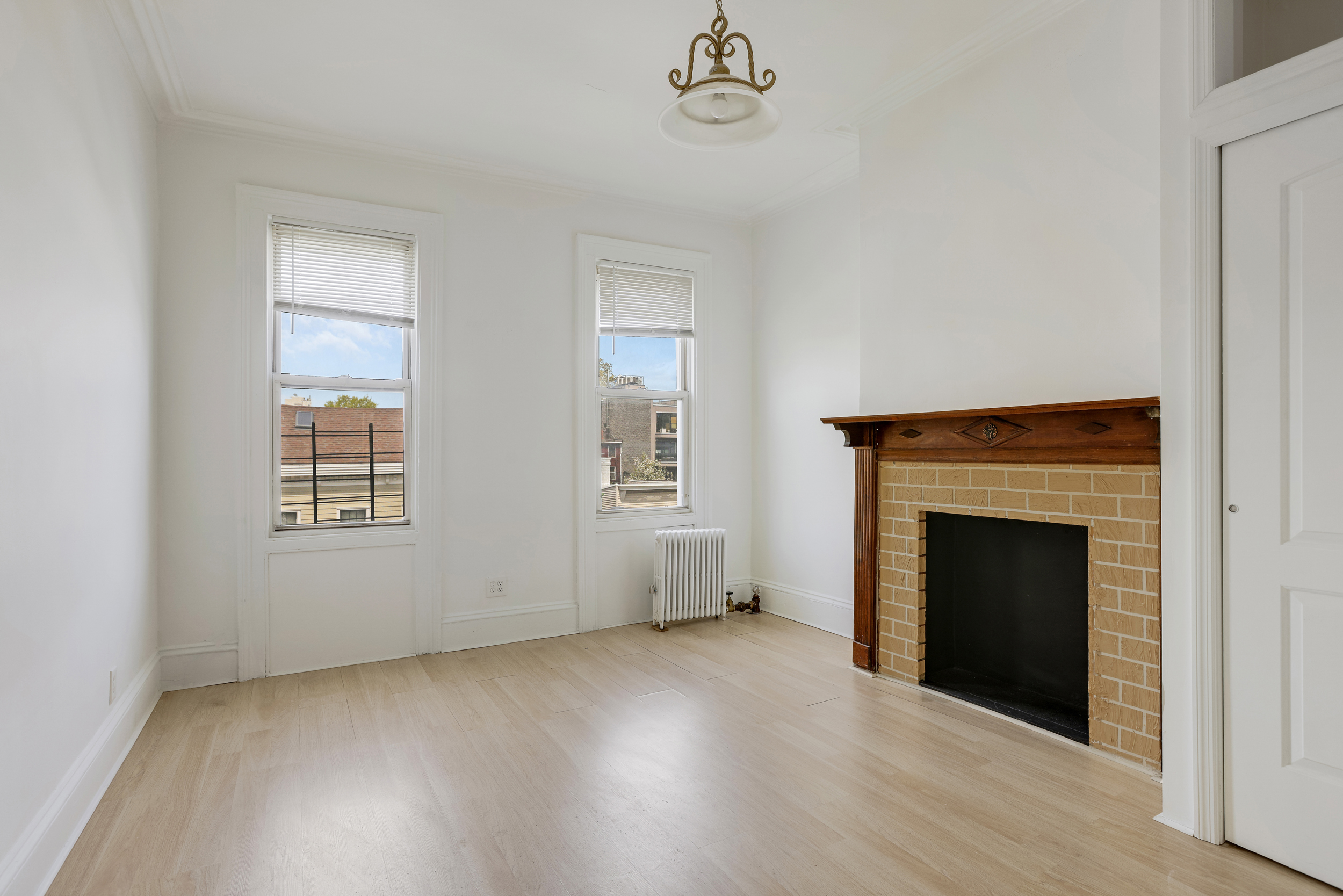 100 Powers Street, Unit 3L Brooklyn, NY 11211 - Photo 5 of 17 an empty room with windows and fireplace