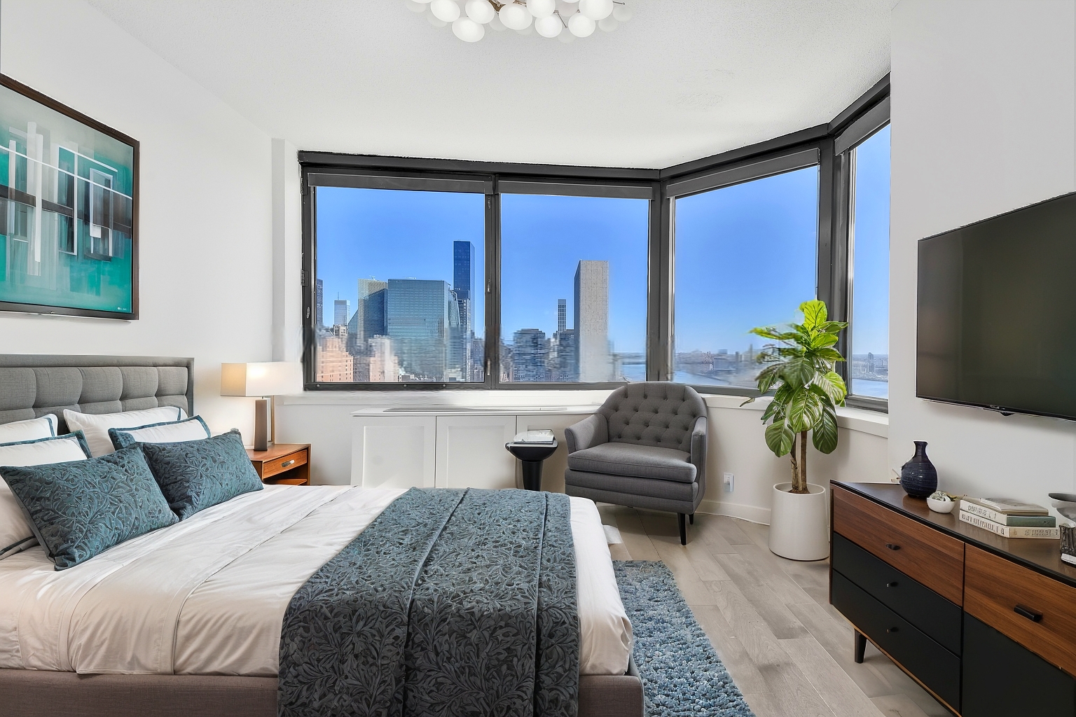 415 East 37th Street, Unit 32G Manhattan, NY 10016 - Photo 3 of 19 a bedroom with a large bed and a flat screen tv
