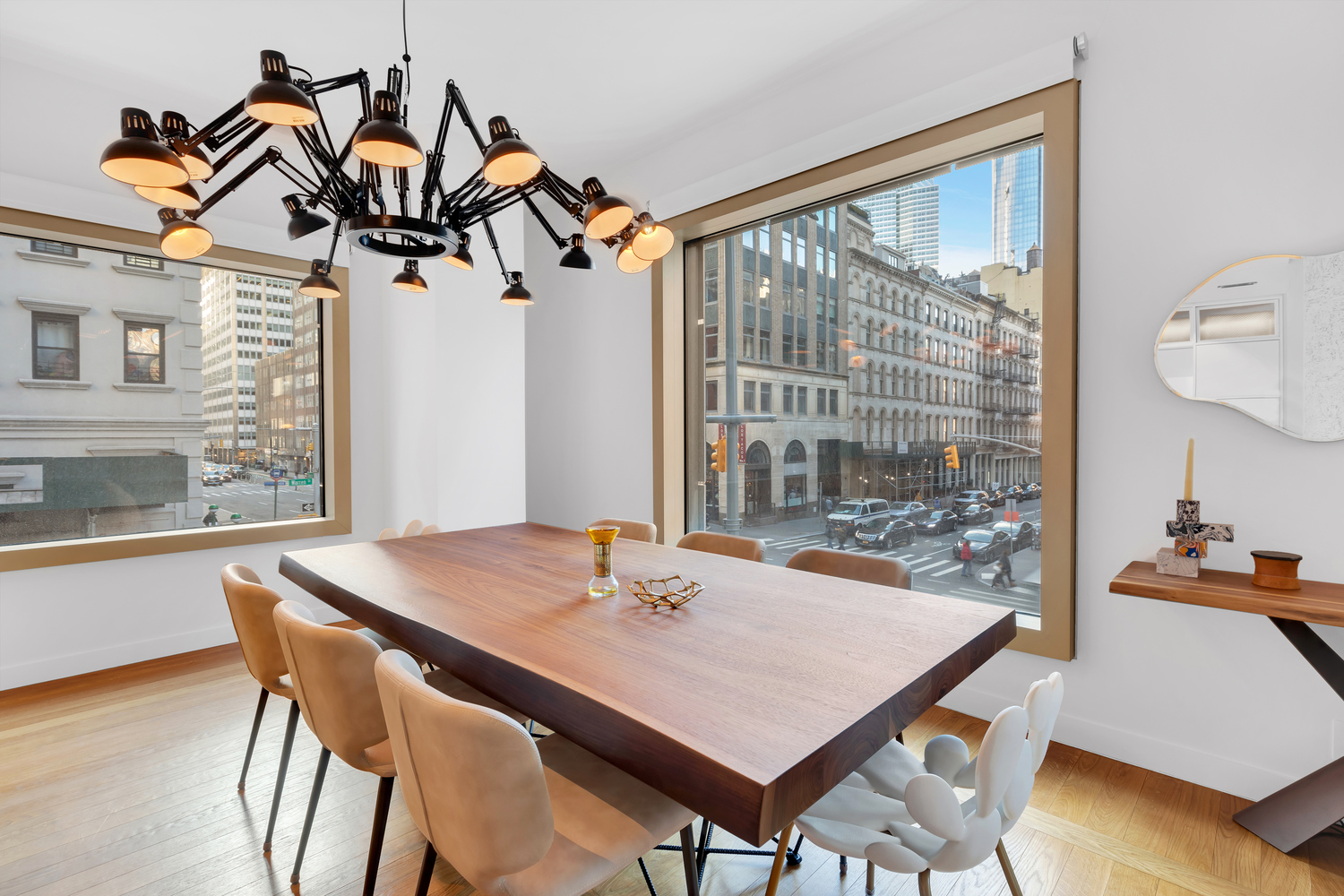 30 Warren Street, Unit 2C Manhattan, NY 10007 - Photo 4 of 18 a view of a dining room and livingroom with furniture wooden floor and a chandelier