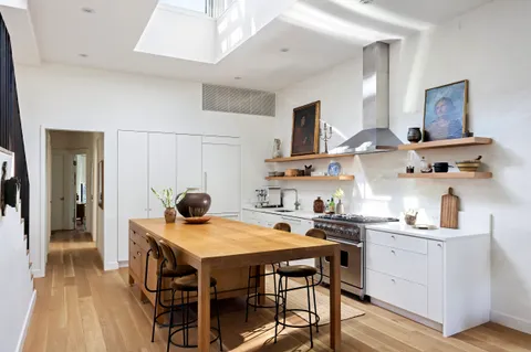 a kitchen with a dining table and chairs