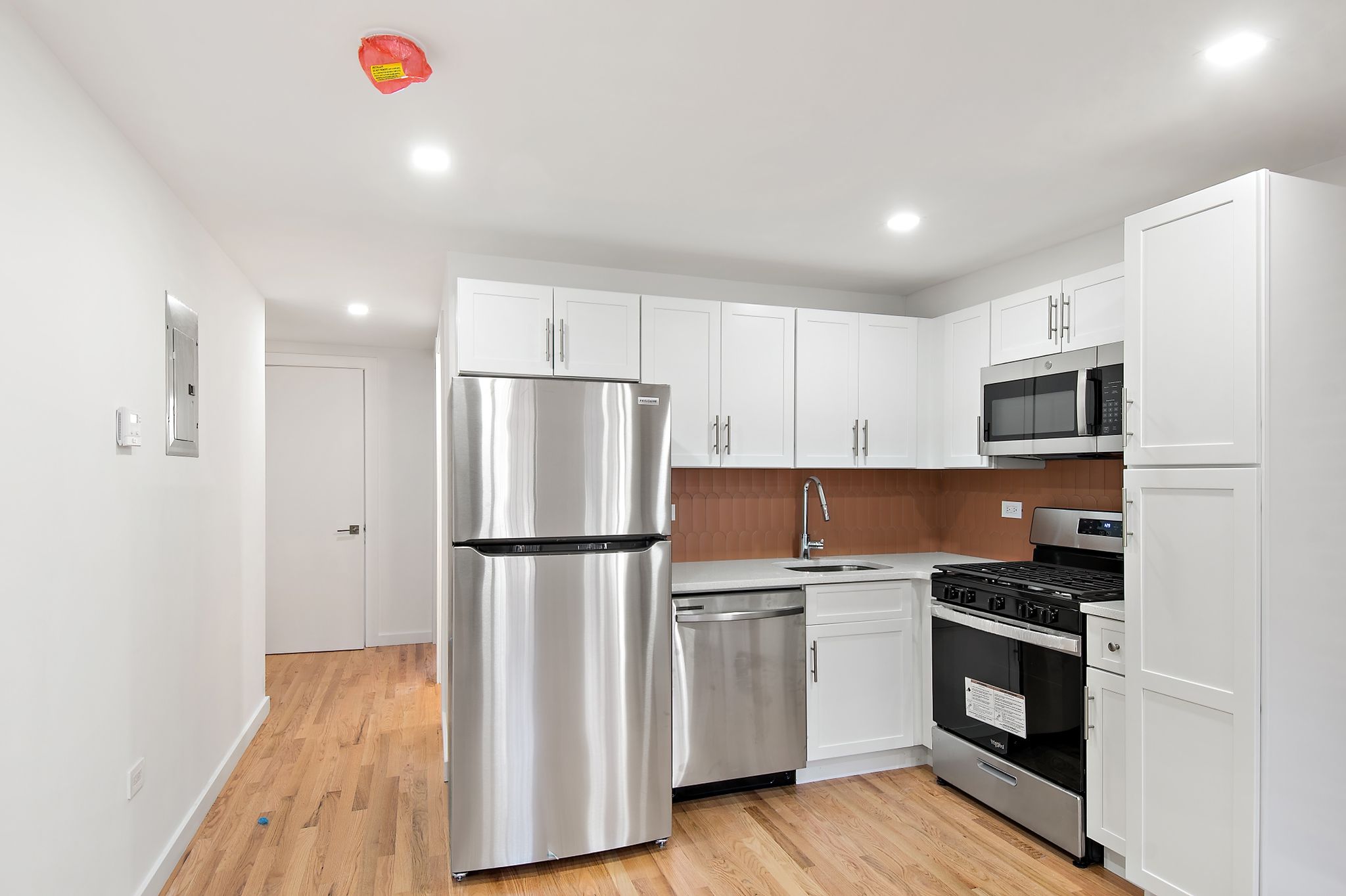 181 Kosciuszko Street Brooklyn, NY 11216 - Photo 20 of 20 a kitchen with a refrigerator a stove top oven a sink and dishwasher