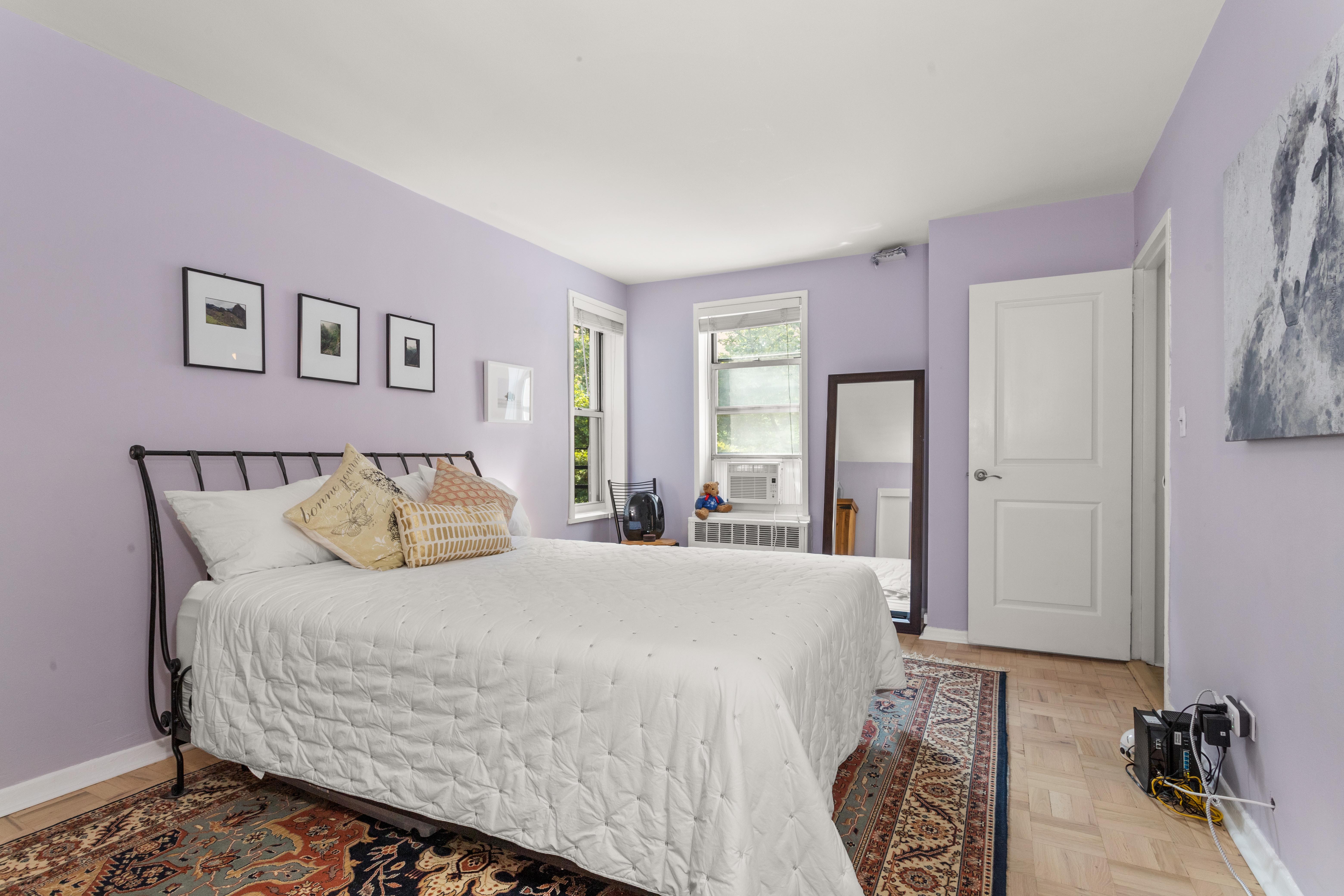 66 Overlook Terrace, Unit 4K Manhattan, NY 10040 - Photo 13 of 26 a bedroom with a large bed and a window