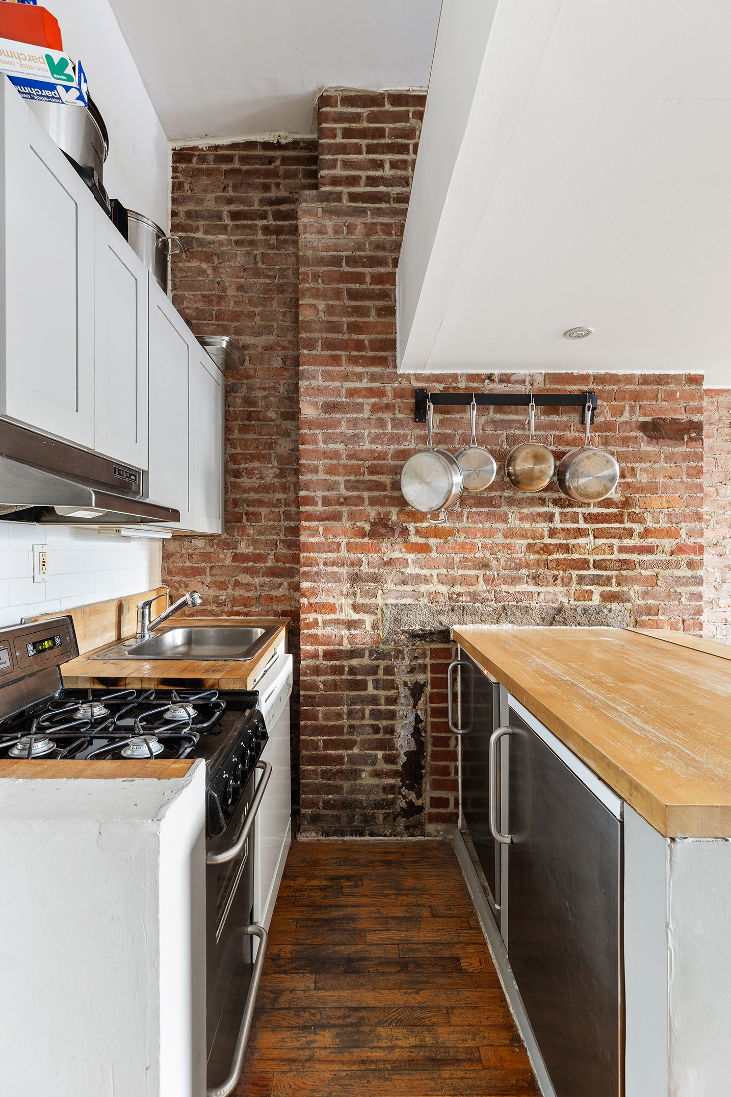 147 Sullivan Street, Unit 5C Manhattan, NY 10012 - Photo 3 of 6 a kitchen with stainless steel appliances a stove and a sink