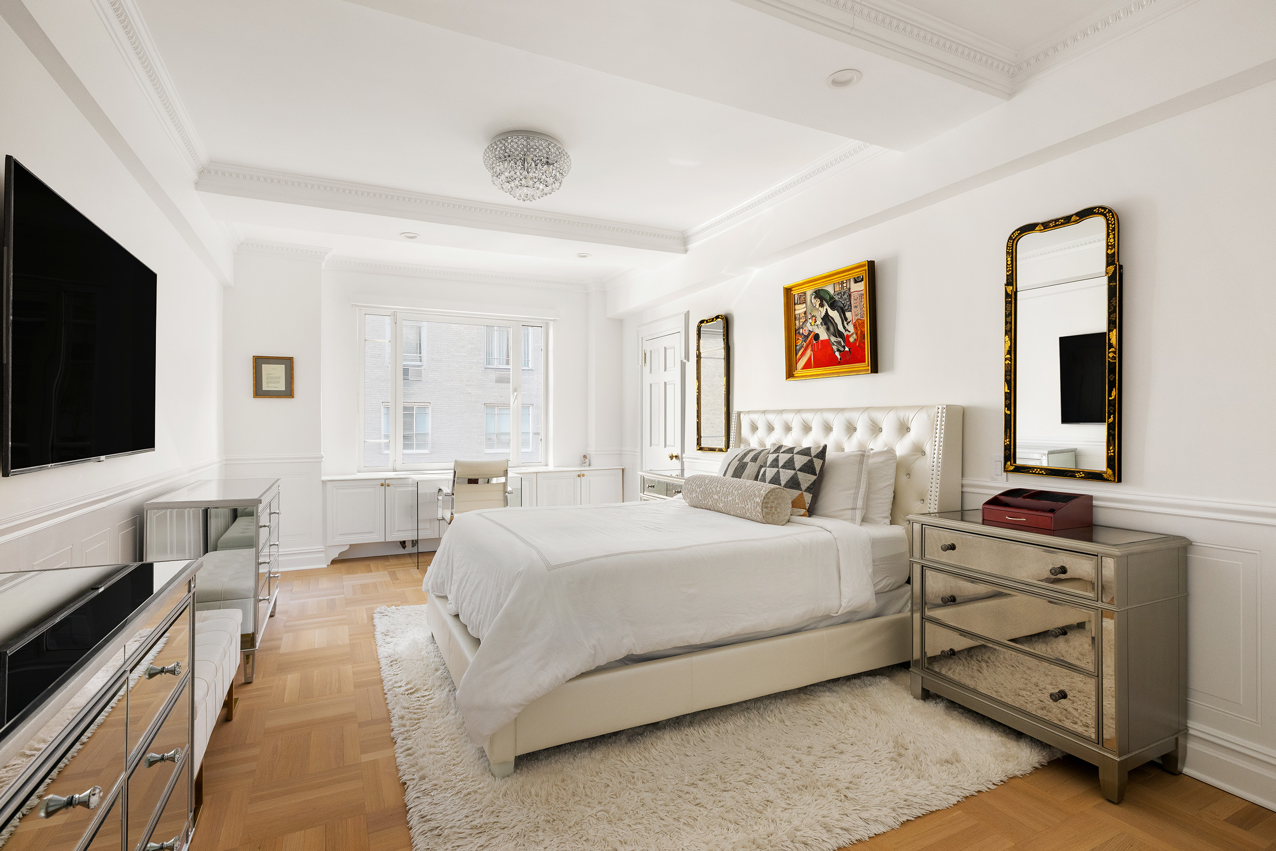 875 5th Avenue, Unit 8D Manhattan, NY 10065 - Photo 7 of 13 a bedroom with a bed and a flat screen tv