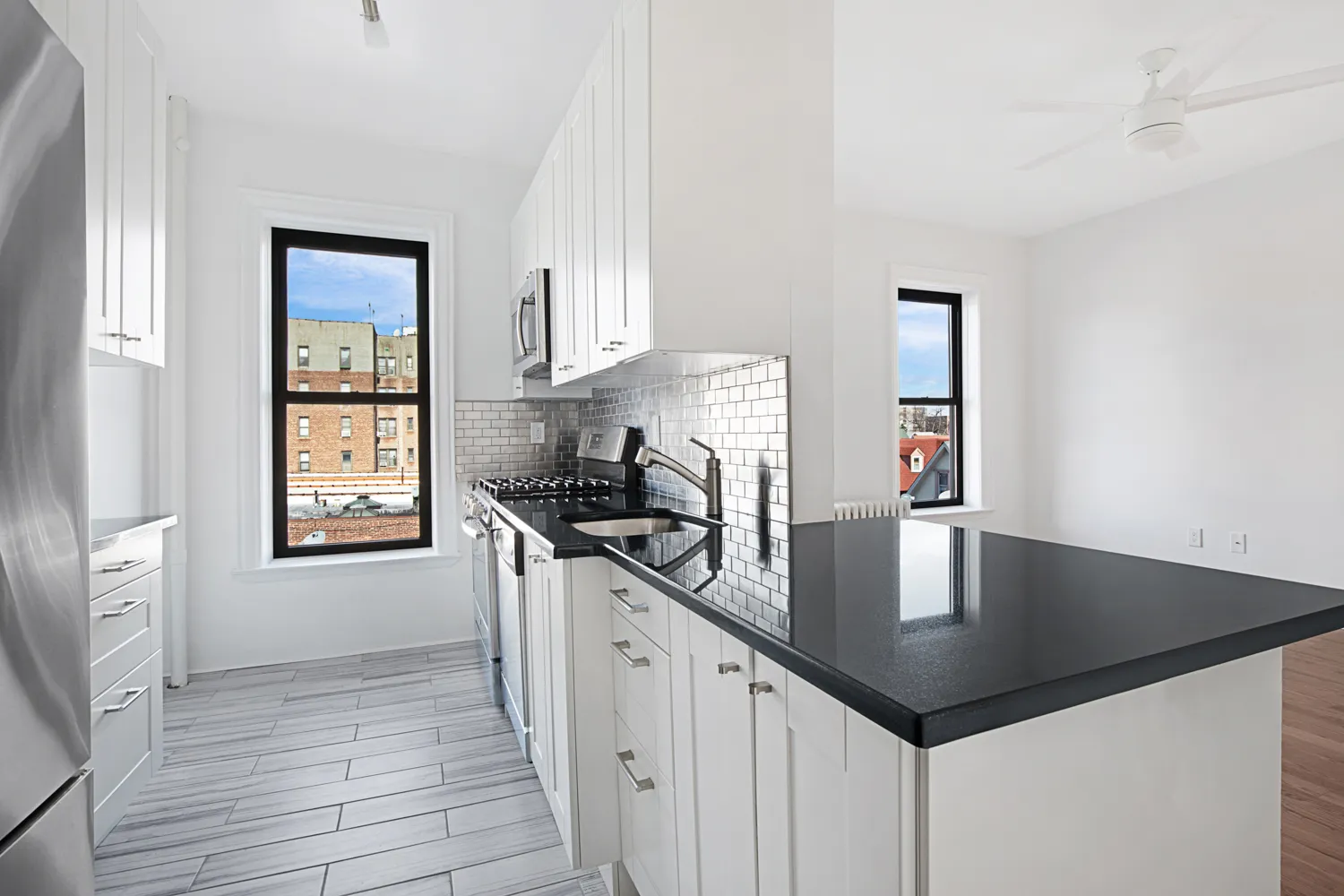 a kitchen with stainless steel appliances granite countertop a sink a stove and a microwave