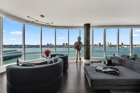 a living room with furniture and a floor to ceiling window