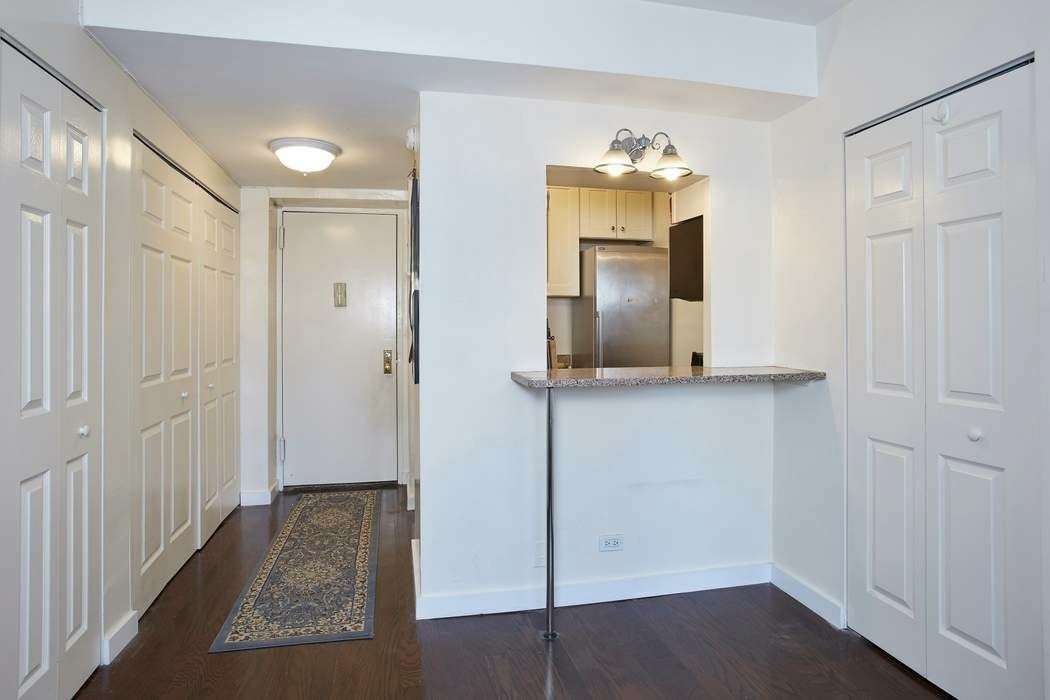 111 3rd Avenue, Unit PHK Manhattan, NY 10003 - Photo 4 of 11 wooden floor in an entryway with a chandelier