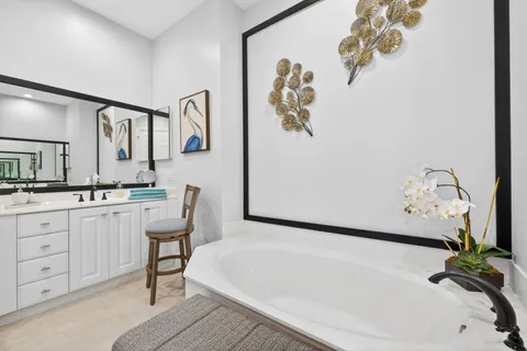 a white bath tub sitting next to a bathroom sink