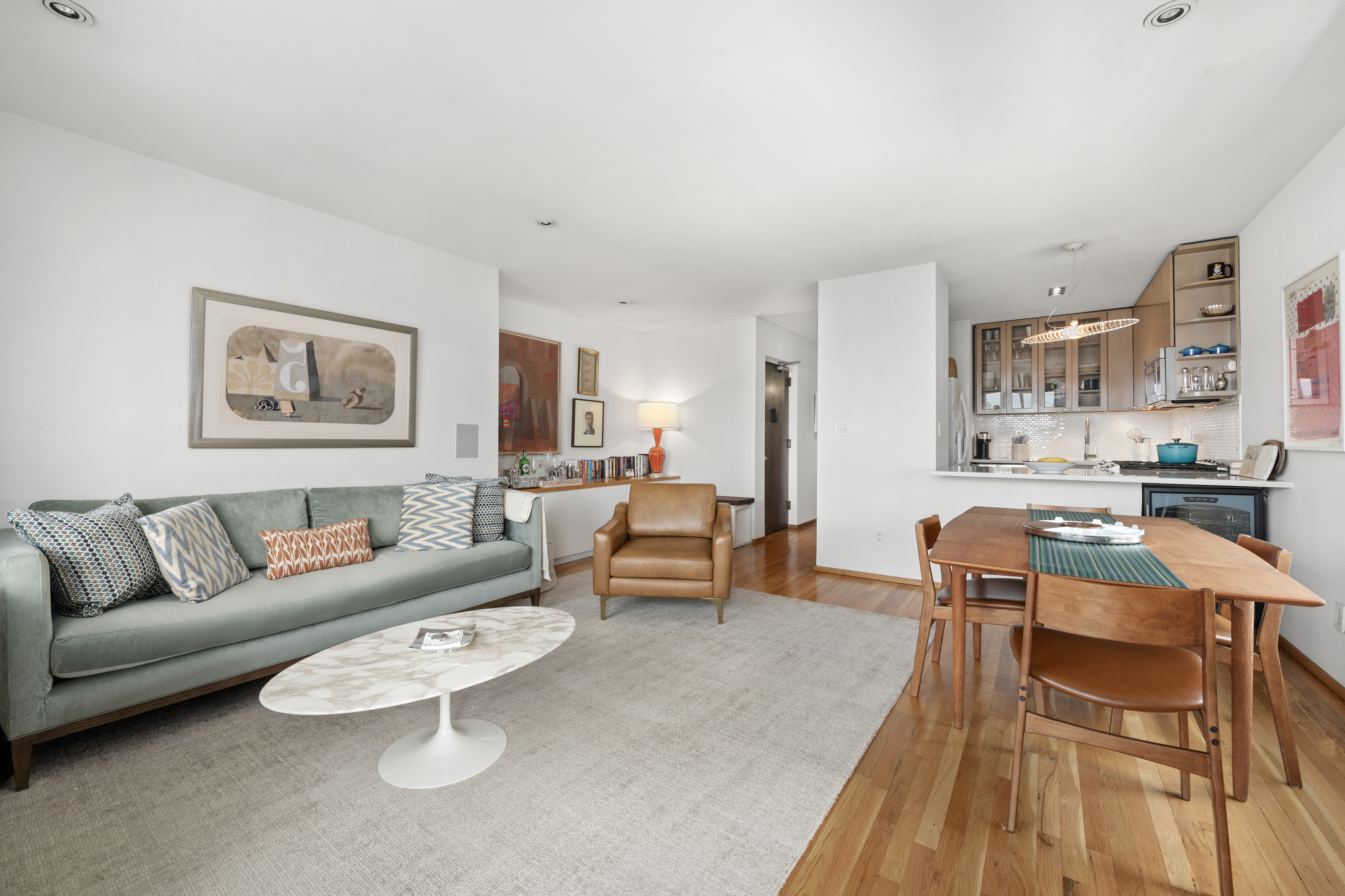 181 7th Avenue, Unit 11A Manhattan, NY 10011 - Photo 4 of 13 a living room with furniture and a table