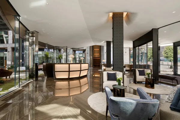a living room with furniture and a floor to ceiling window