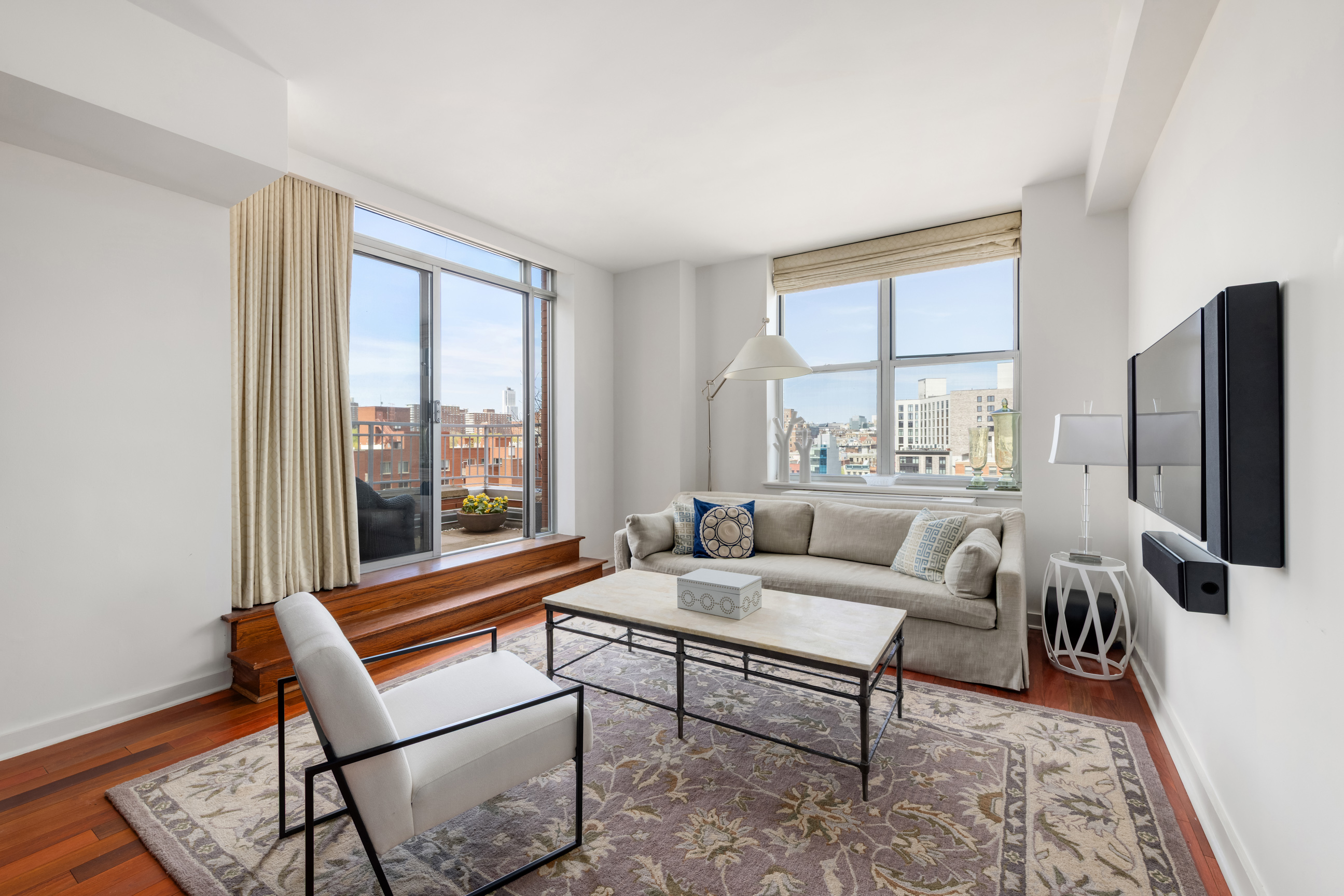301 West 118th Street, Unit PH1C Manhattan, NY 10026 - Photo 1 of 12 a living room with furniture and a flat screen tv