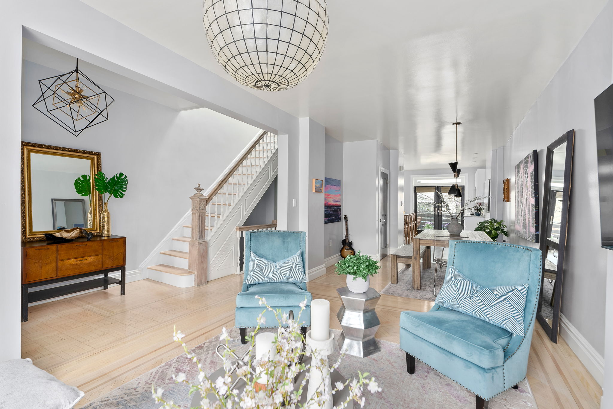 a living room with furniture and a chandelier