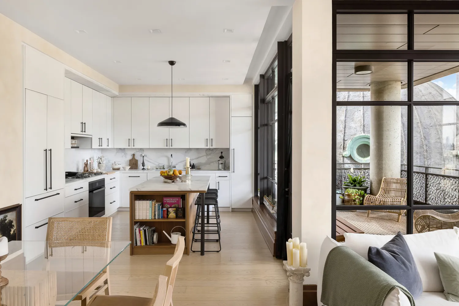 a kitchen with a dining table chairs stove and white cabinets
