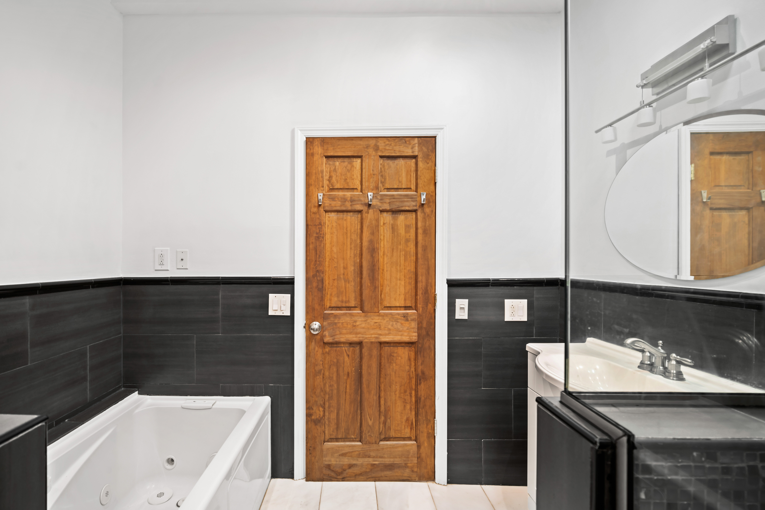 60-13 Menahan Street, Unit 1 Queens, NY 11385 - Photo 15 of 19 a bathroom with a sink and a mirror