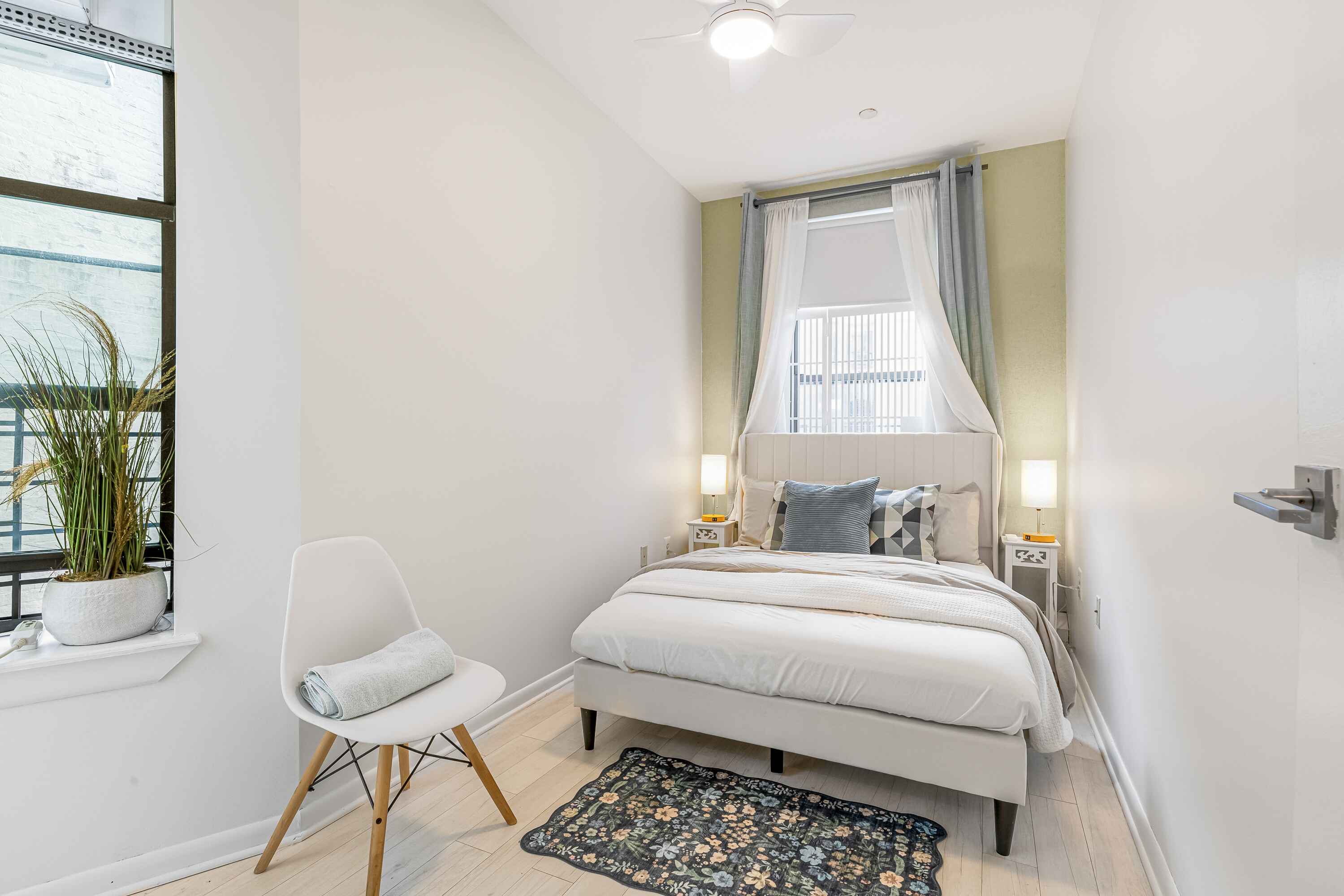 108 West 114th Street, Unit 4B Manhattan, NY 10026 - Photo 4 of 11 a bedroom with a bed and a large window