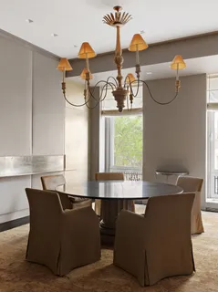 a dining room with furniture and window