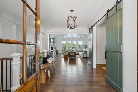 a view of living room with furniture and wooden floor