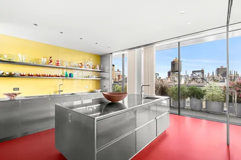 a kitchen with a sink and a stove top oven