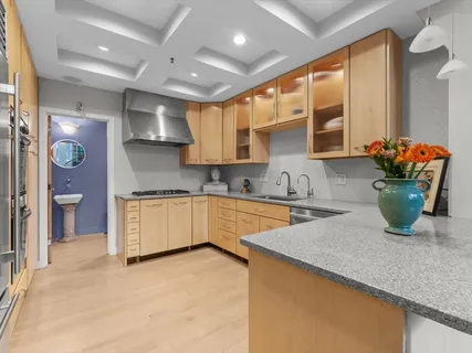 a kitchen with stainless steel appliances granite countertop sink stove and refrigerator