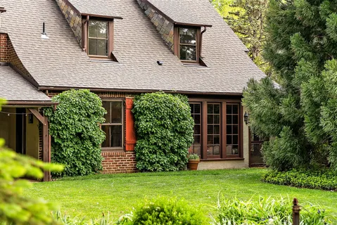 a front view of a house with garden