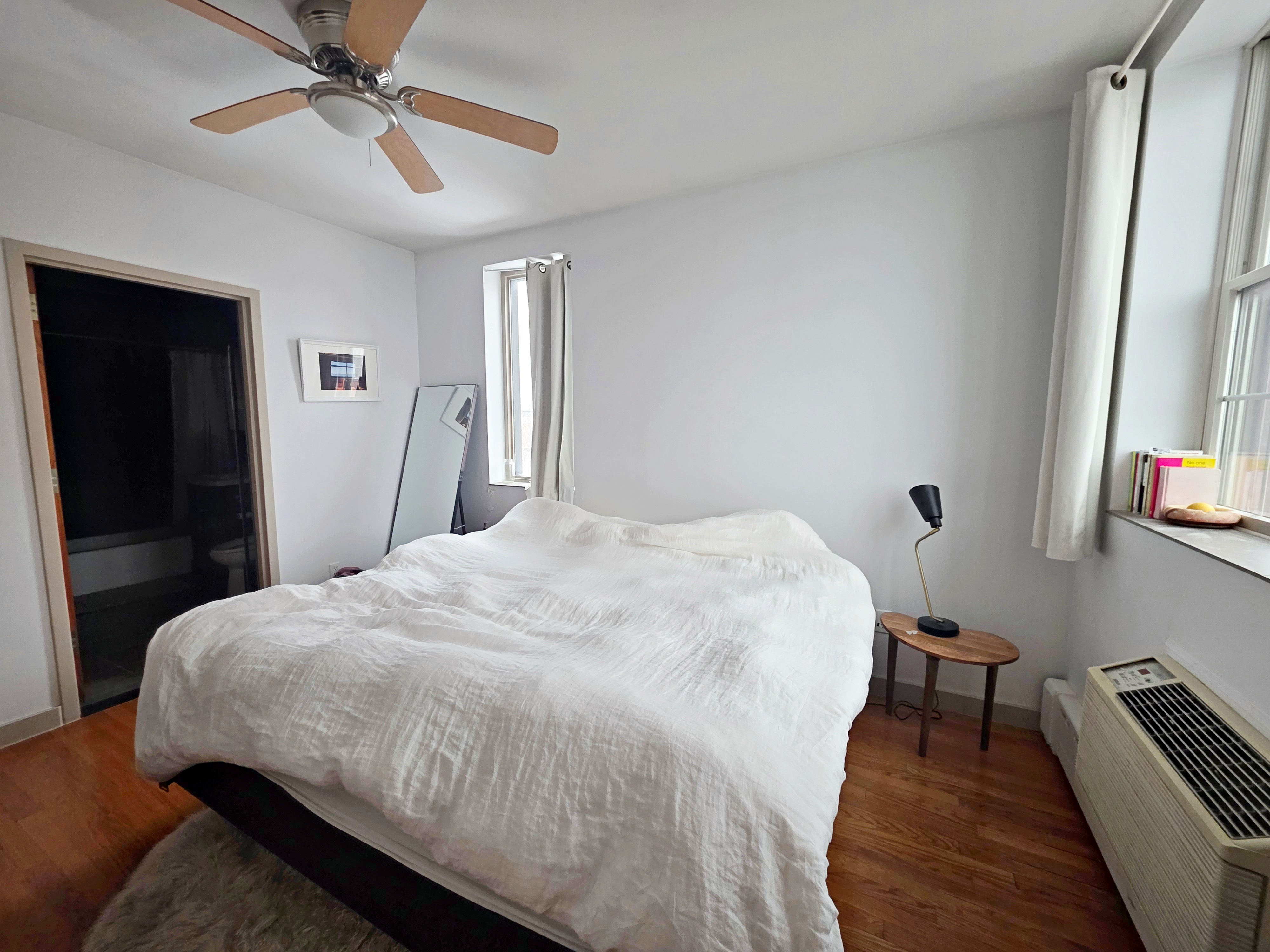 713 Metropolitan Avenue, Unit 4R Brooklyn, NY 11211 - Photo 5 of 11 a bedroom with a bed and a chandelier