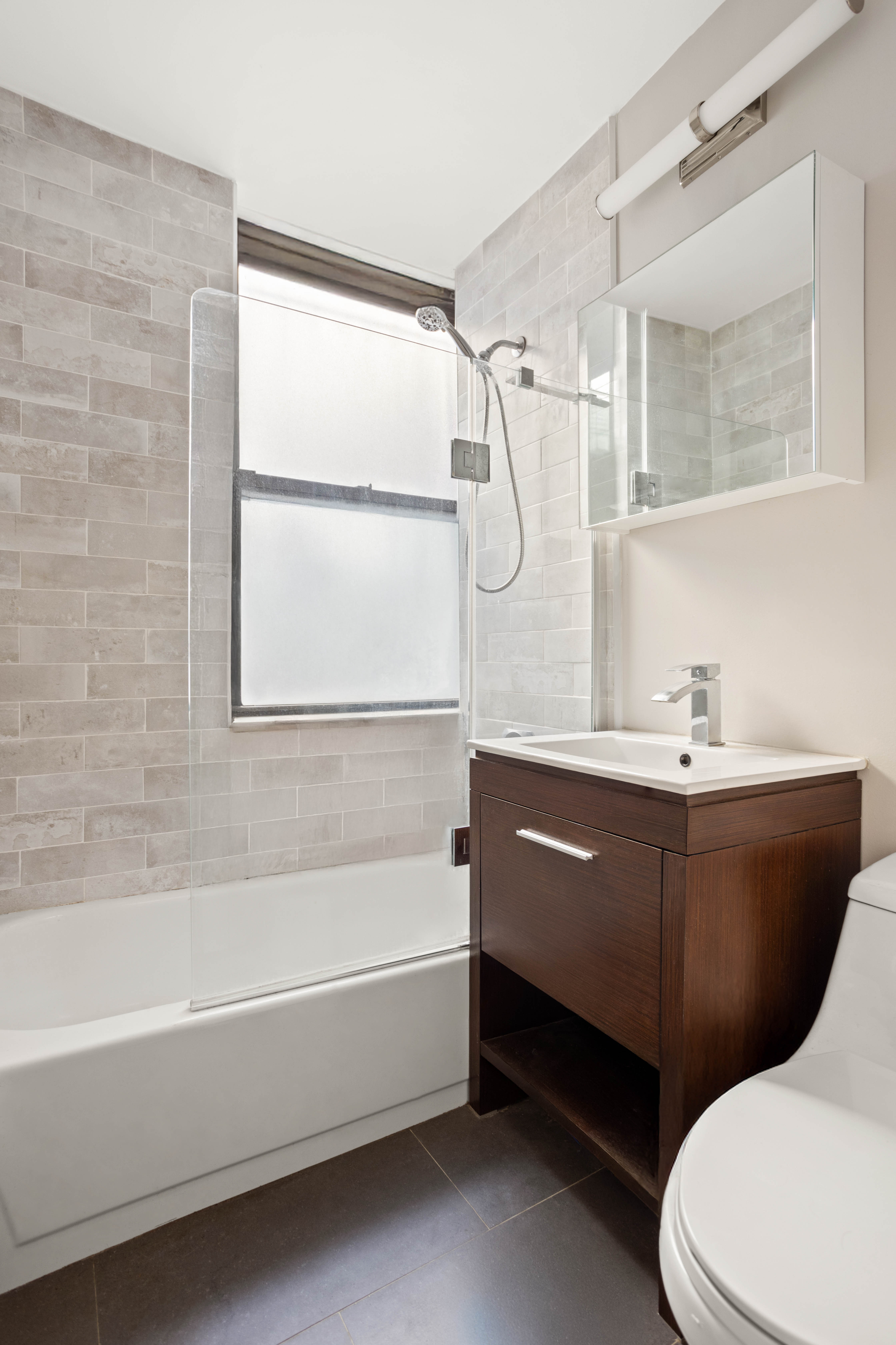 4 West 101st Street, Unit 5 Manhattan, NY 10025 - Photo 4 of 9 a bathroom with a sink a bathtub and a shower