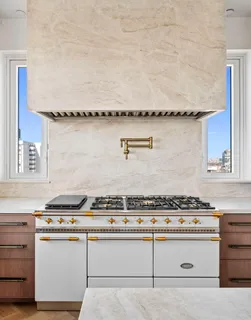 a white stove top oven sitting inside of a kitchen