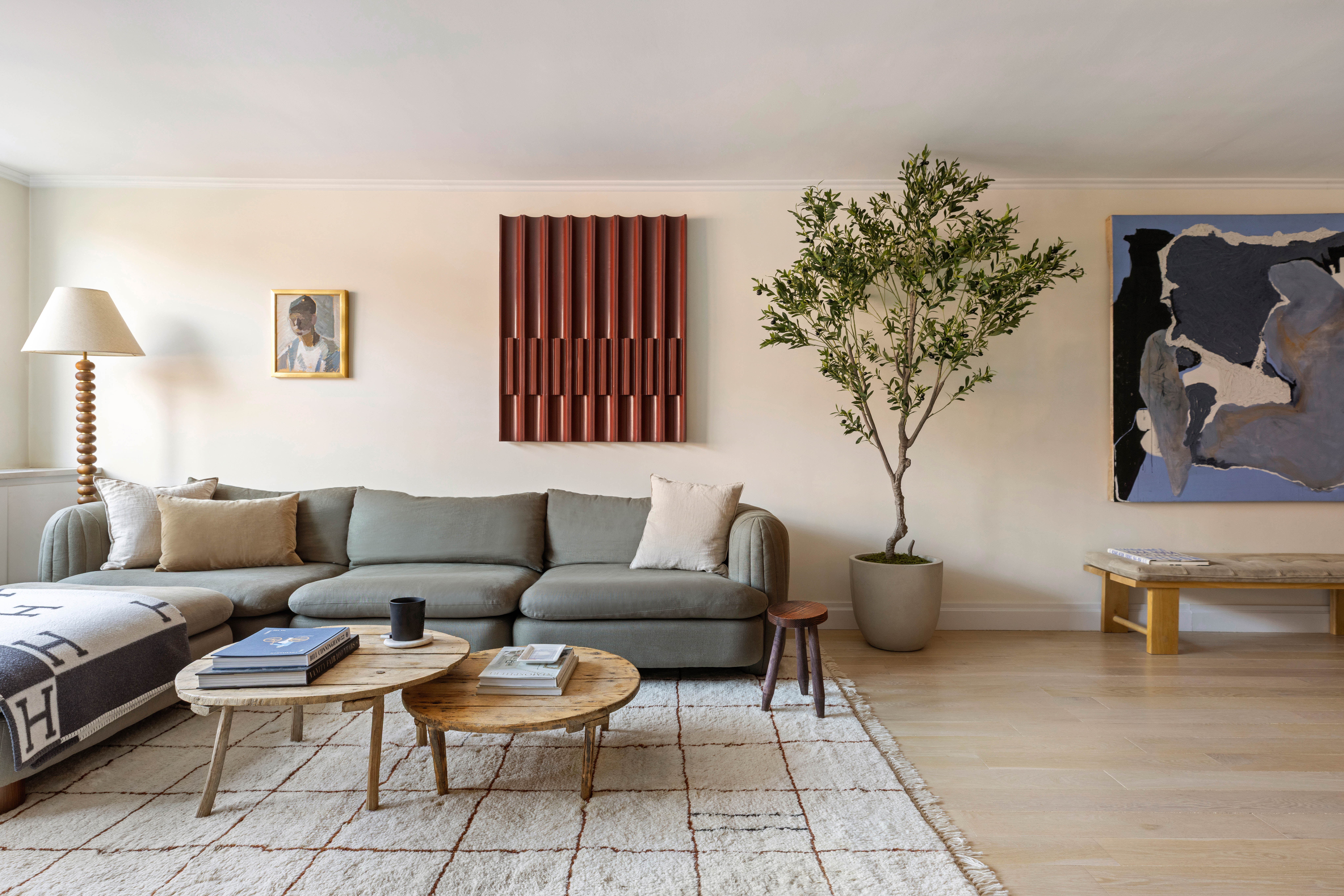 61 Jane Street, Unit 4L Manhattan, NY 10014 - Photo 4 of 11 a living room with furniture a chandelier and a potted plant