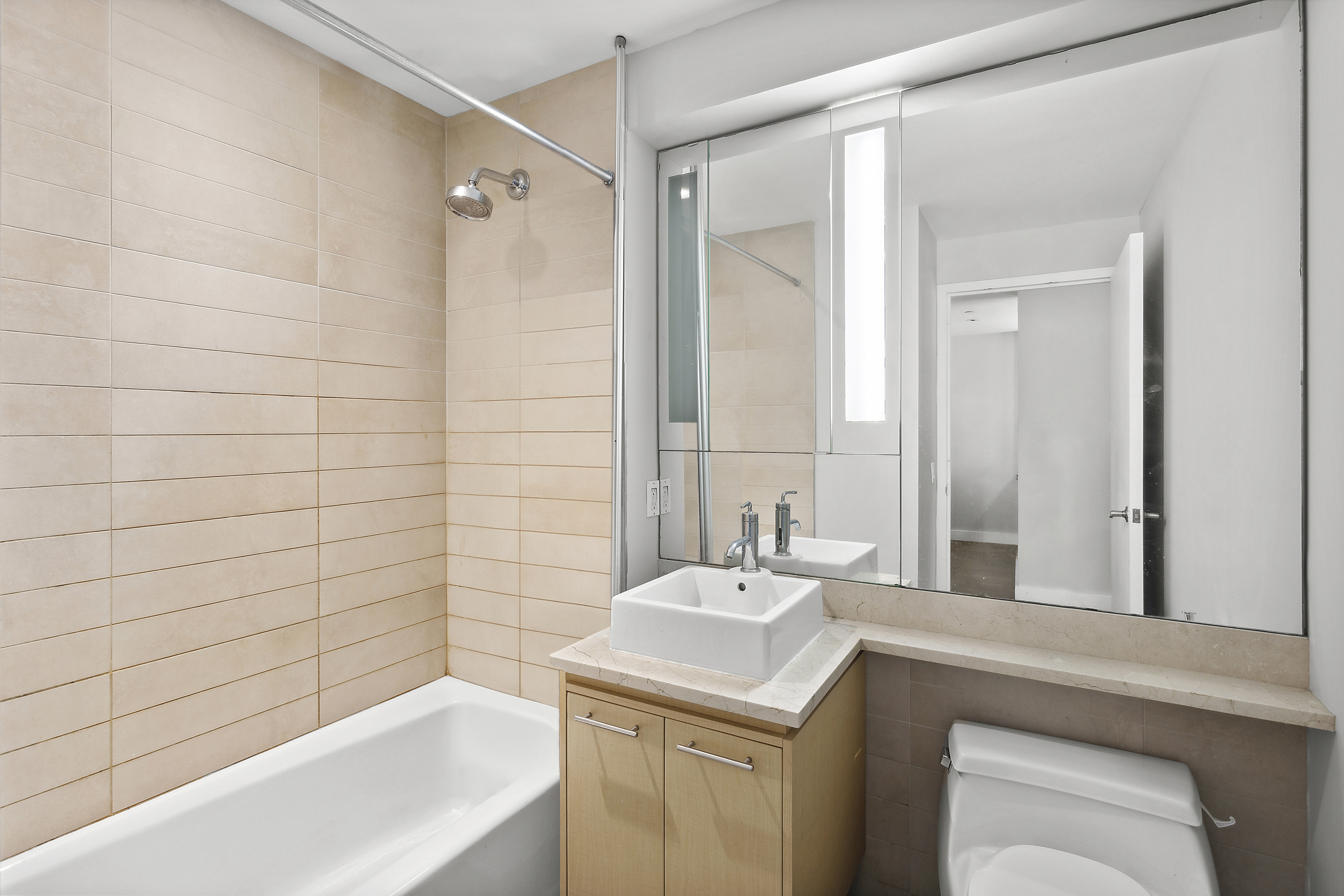 306 Gold Street, Unit 7J Brooklyn, NY 11201 - Photo 4 of 4 a bathroom with a sink and a mirror