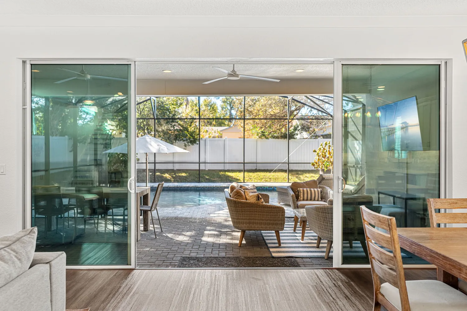 a living room with a floor to ceiling window and wooden floor