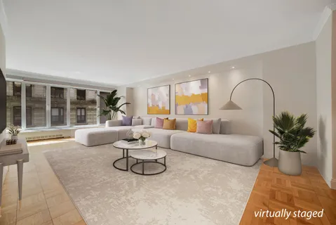 a living room with furniture and a potted plant