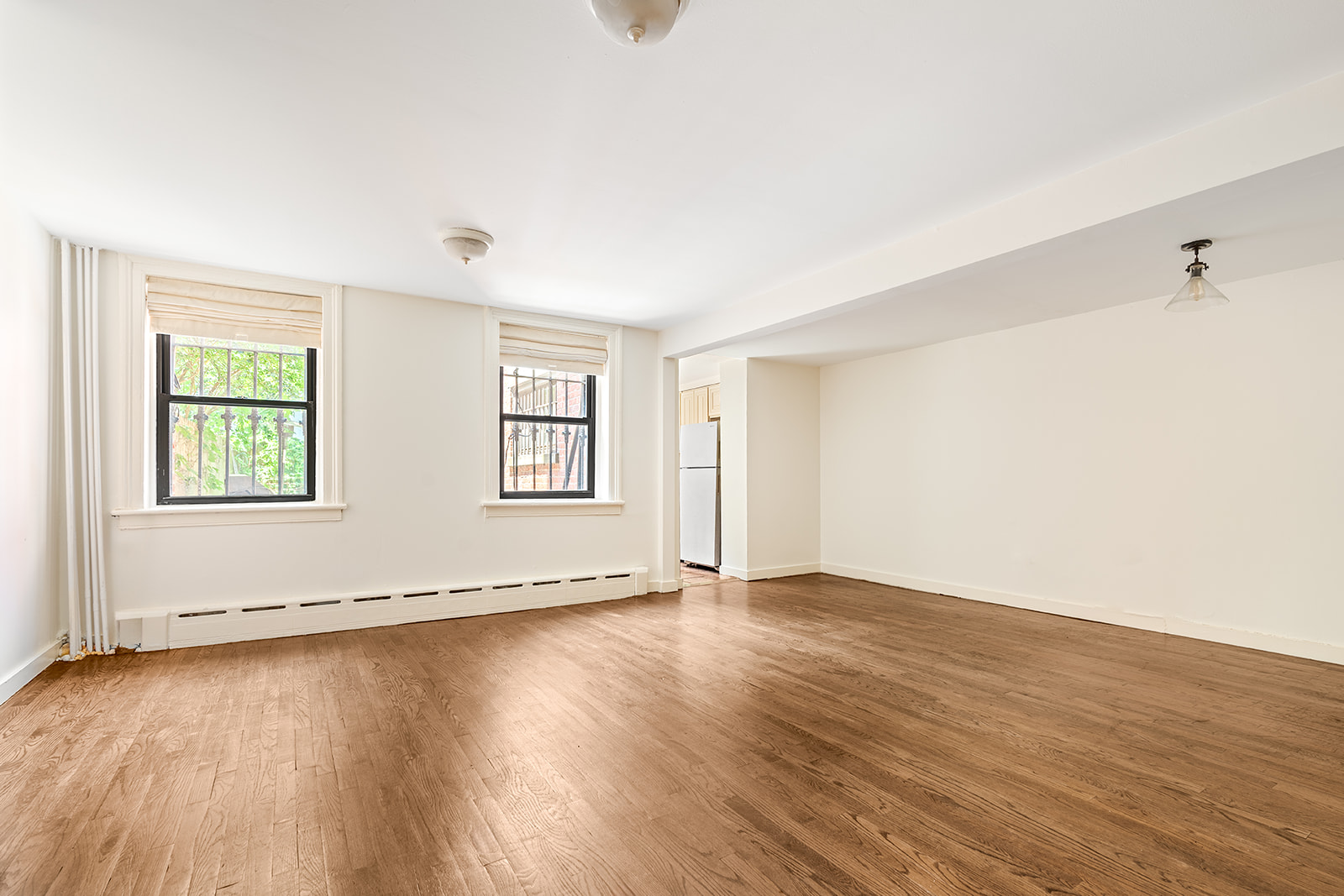 52 South Portland Avenue, Unit 1 Brooklyn, NY 11217 - Photo 3 of 7 an empty room with wooden floor and windows