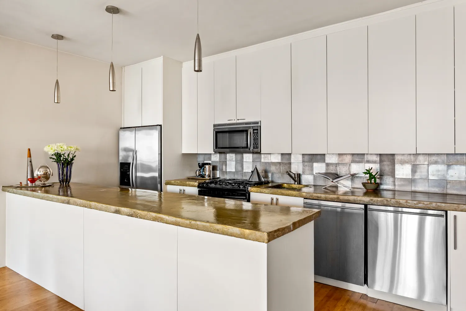 a kitchen with stainless steel appliances granite countertop a sink a stove and refrigerator