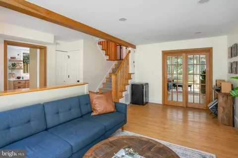 a living room with furniture and wooden floor