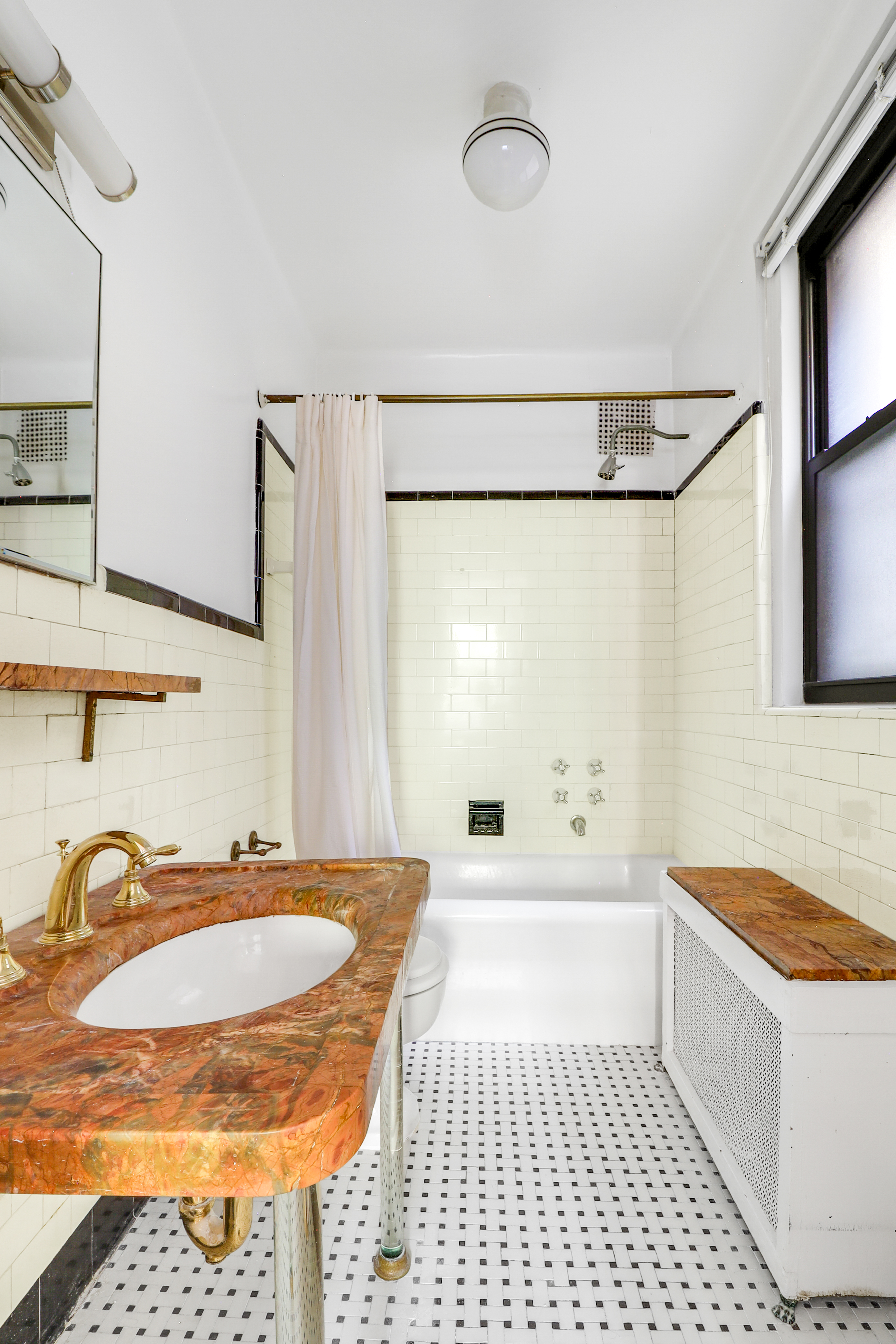 50 Riverside Drive, Unit 5E Manhattan, NY 10024 - Photo 12 of 22 a bathroom with a sink a bathtub and a shower