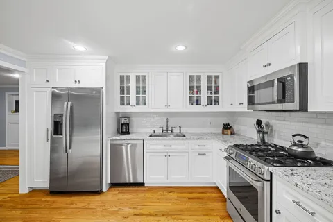 a kitchen with stainless steel appliances granite countertop a stove and a sink