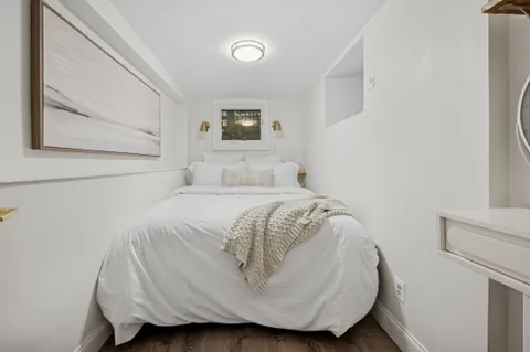 a bedroom with a bed and a wall painting