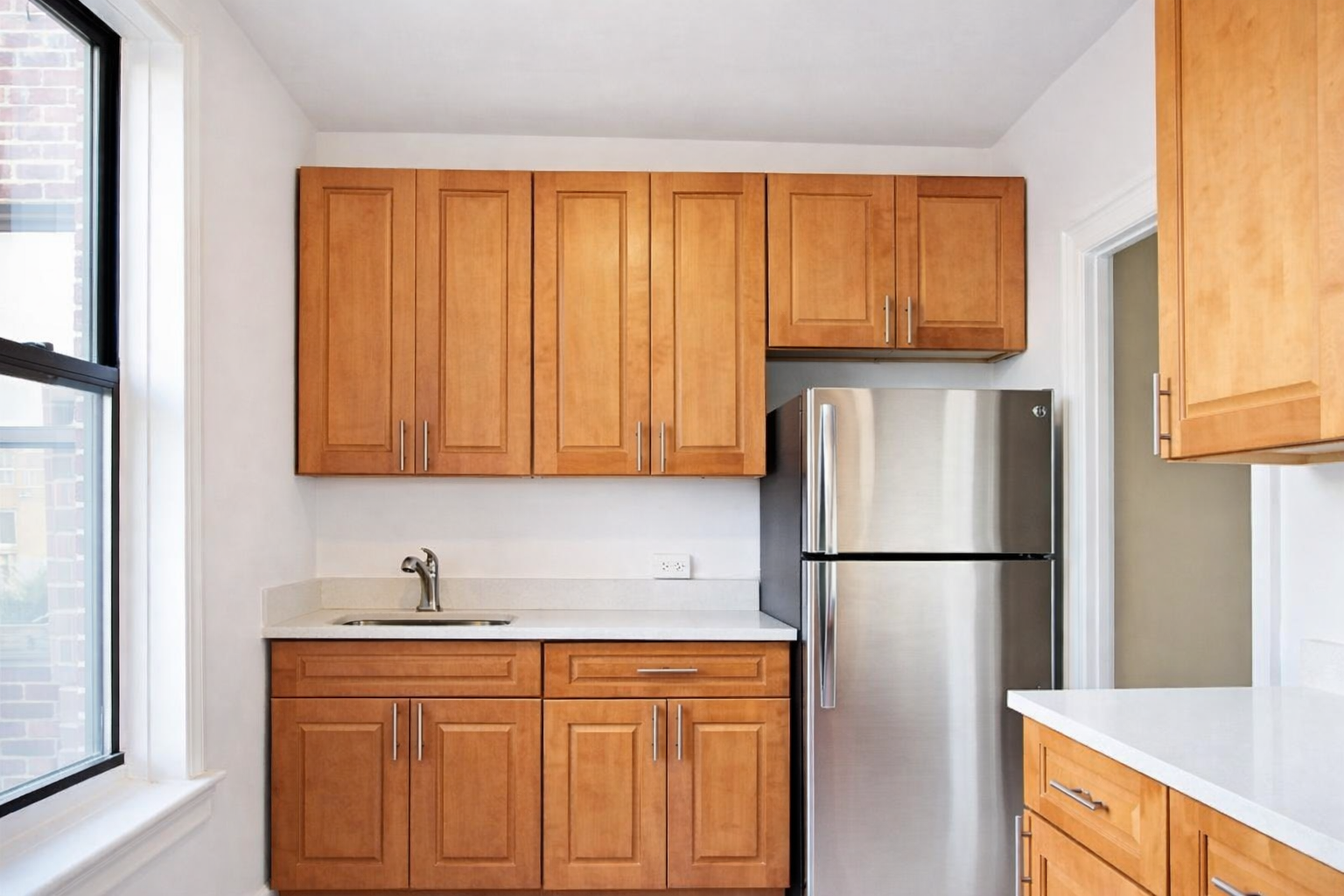 28-23 42nd Street, Unit D5 Queens, NY 11103 - Photo 1 of 10 a kitchen with stainless steel appliances granite countertop a refrigerator and a sink