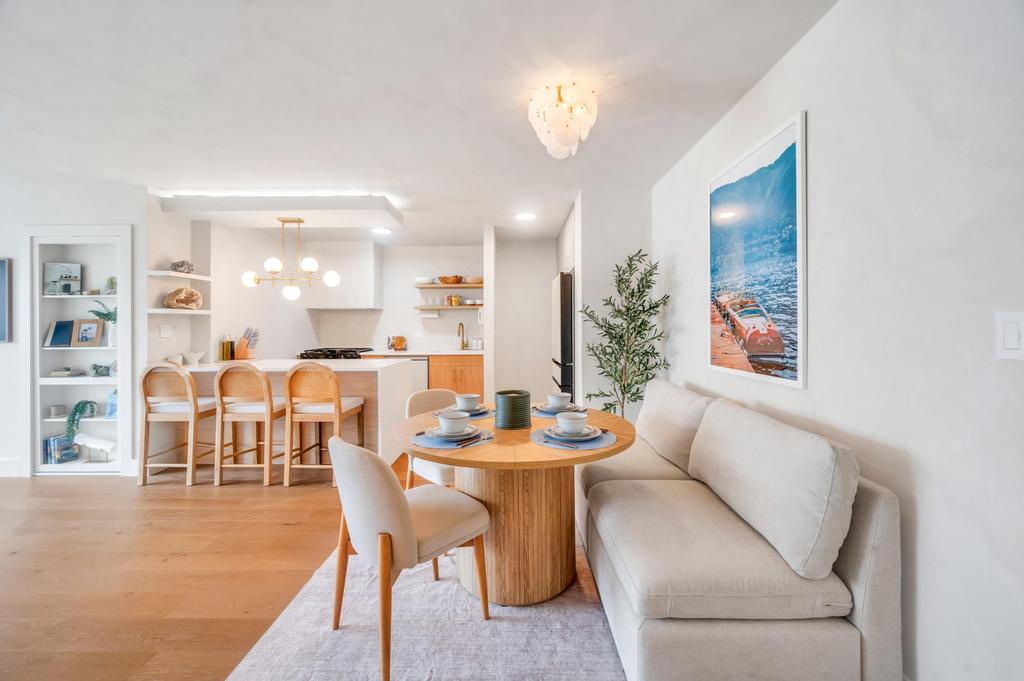 175 West 12th Street, Unit 5E Manhattan, NY 10011 - Photo 2 of 22 a dining room with furniture and a chandelier
