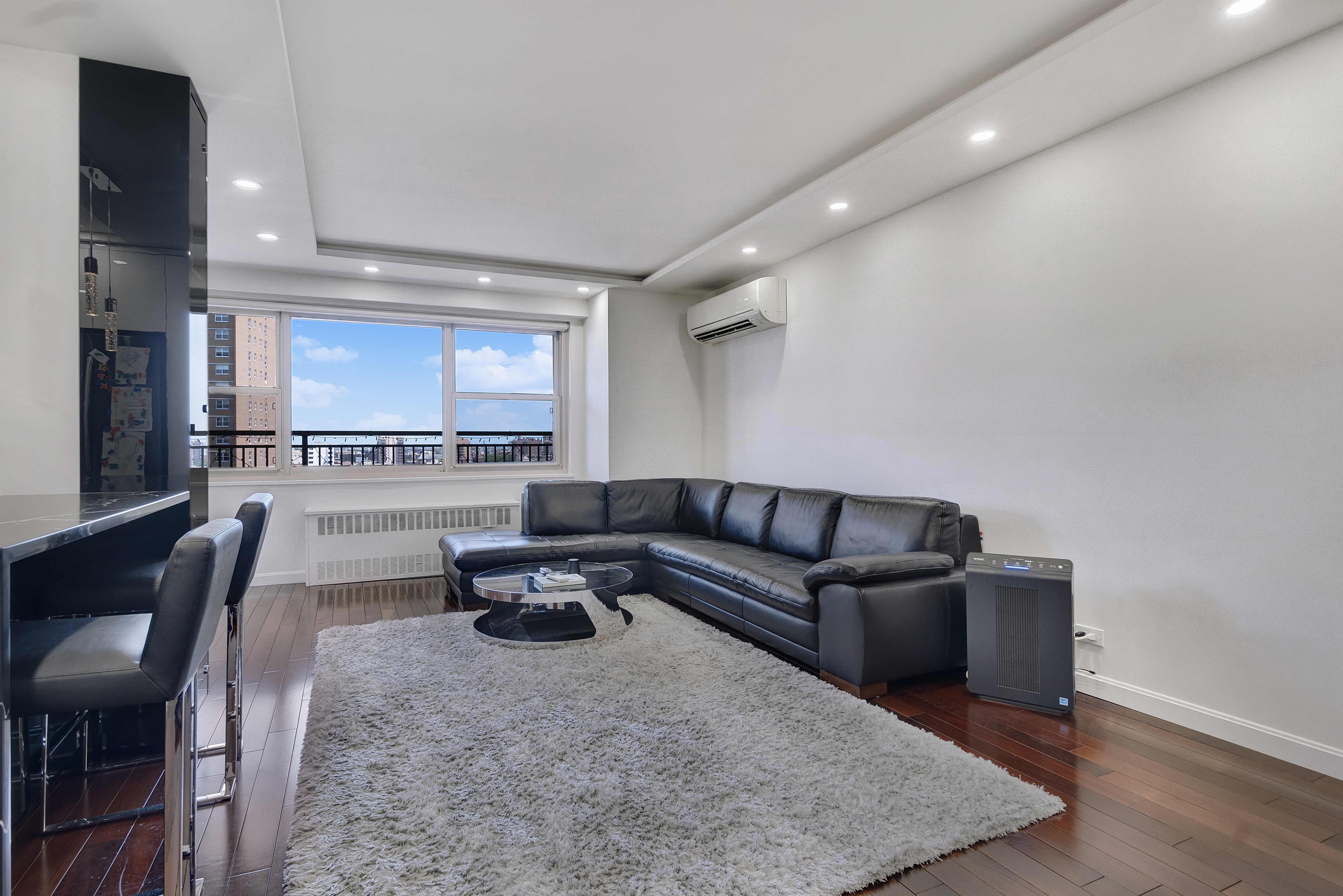 448 Neptune Avenue, Unit 14L Brooklyn, NY 11224 - Photo 5 of 20 a living room with furniture and a wooden floor