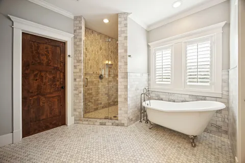a spacious bathroom with a bathtub and shower