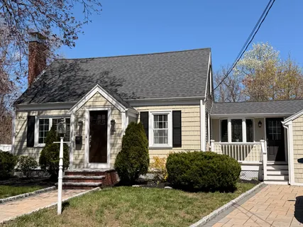a view of a brick house with potted plants