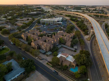 an aerial view of a house with garden space and street view
