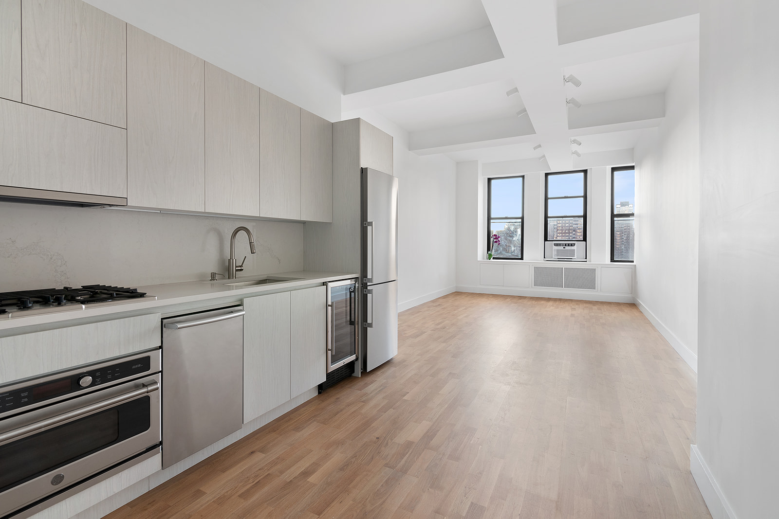 315 7th Avenue, Unit 11E Manhattan, NY 10001 - Photo 5 of 7 a kitchen with granite countertop a stove and a refrigerator