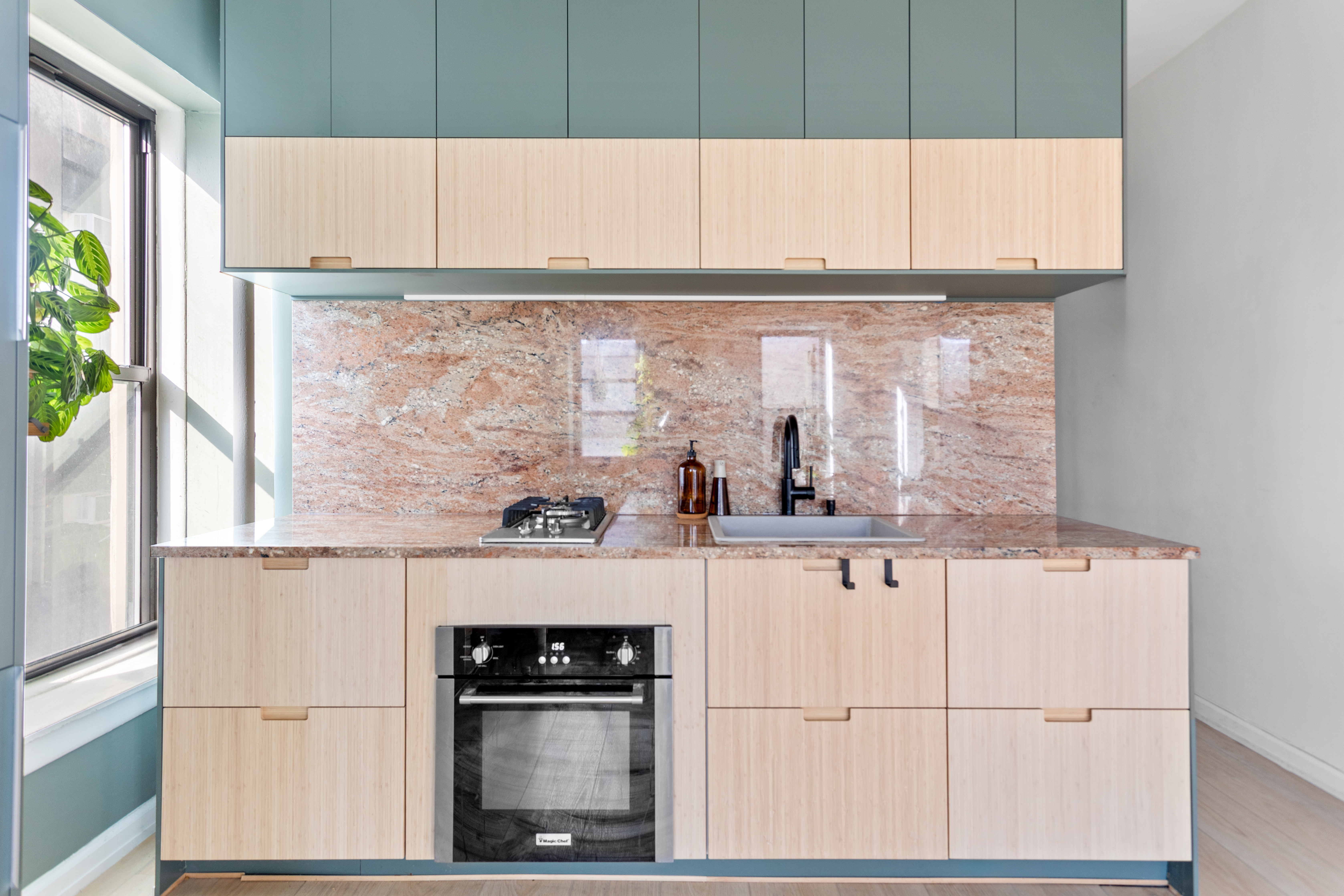 218 Scholes Street, Unit 12 Brooklyn, NY 11206 - Photo 7 of 8 a kitchen with granite countertop white cabinets and white appliances