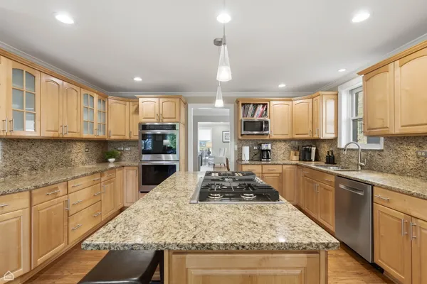 a kitchen with a stove sink cabinets and refrigerator
