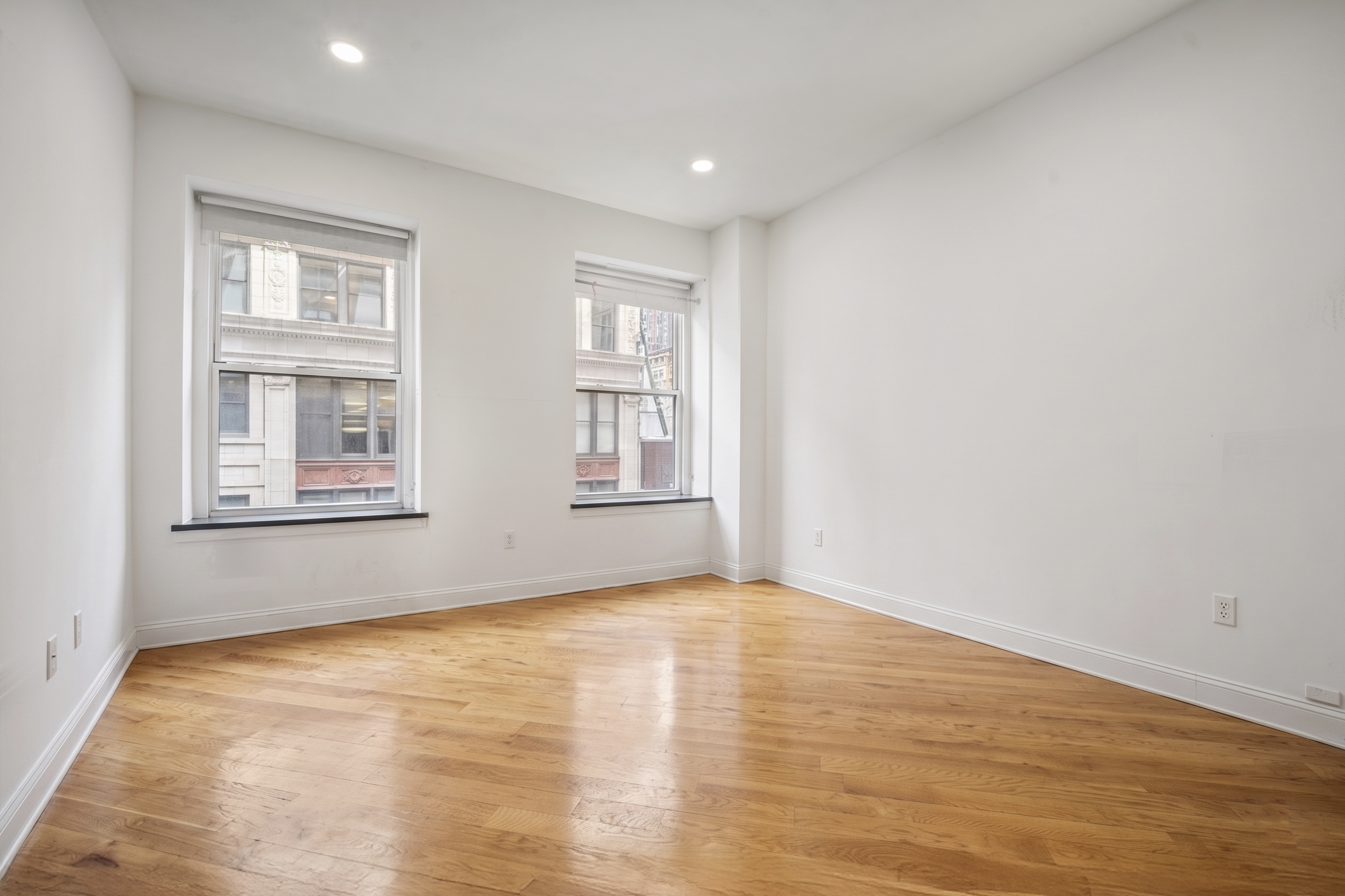 36 West 35th Street, Unit 2A Manhattan, NY 10001 - Photo 10 of 11 a view of empty room with wooden floor and fan