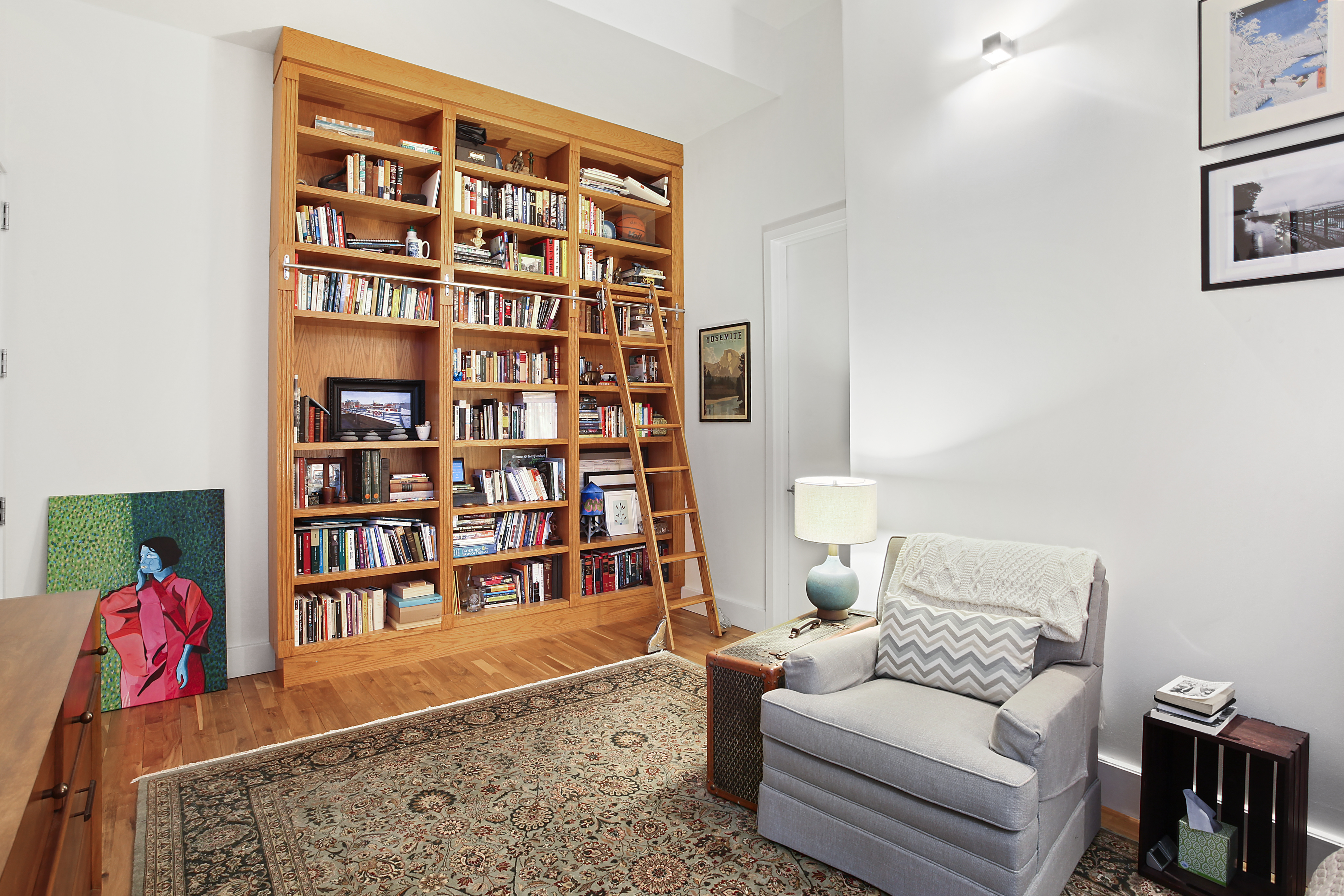 360 Furman Street, Unit 723/724 Brooklyn, NY 11201 - Photo 6 of 63 a living room with furniture and a book shelf