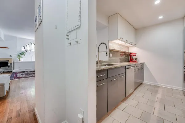 a kitchen with a sink cabinets and wooden floor