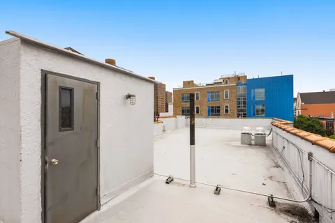 a balcony with white walls and stairs